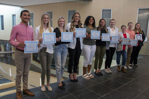 Finalists holding their certificates