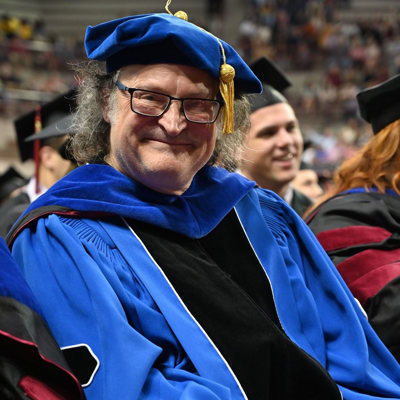 Phil Todd, Instructor in Journalism and Student Publication Advisor, donned his late wife's graduation attire when he earned his master's degree in mass communication from Oklahoma University in 2020.