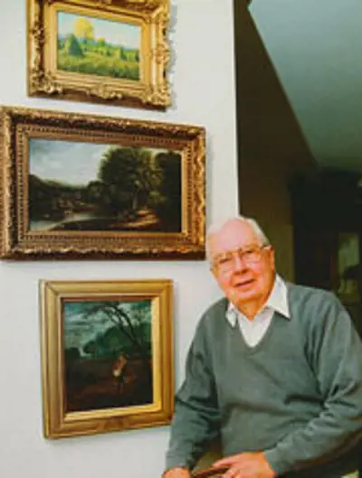 Kenneth Peva McCutchan with paintings.