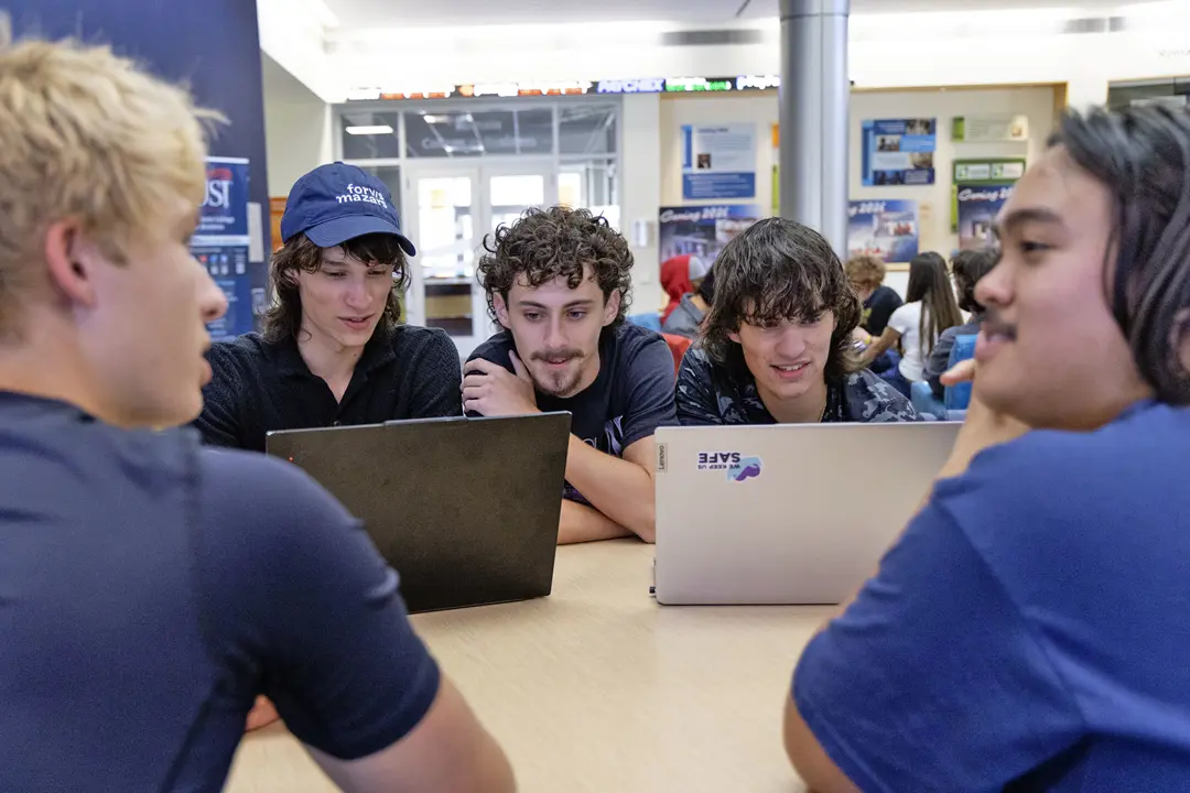 A group of students work together on a project 
