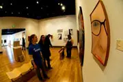 Students looking at painting at 2009 Senior Seminar Exhibition