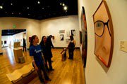 Students looking at painting at 2009 Senior Seminar Exhibition