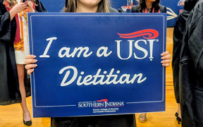 Student holding sign that says "I am a USI Dietitian"