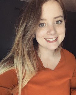 Portrait of Serena Gravil in orange blouse