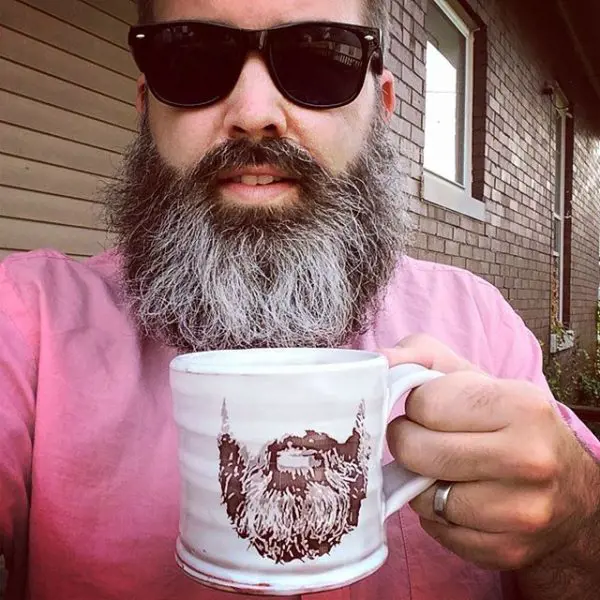 Brian Harper holding a printed mug.