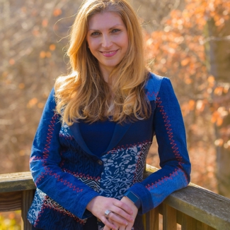 Dr. Vesna Dimetrieska standing on a wooden deck with trees in the background