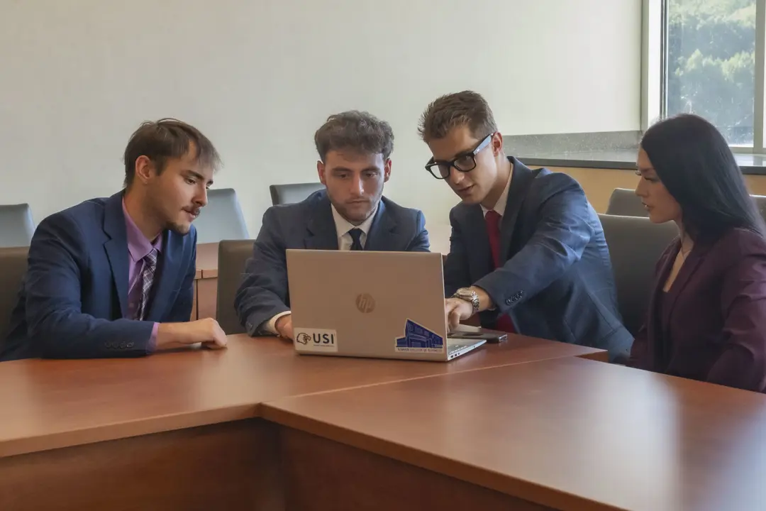 Students from USI's Sales Club work together on a project