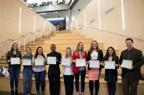 Students holding their certificates